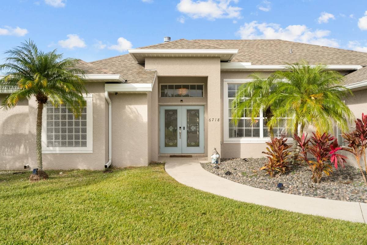 Front entrance with tropical landscaping